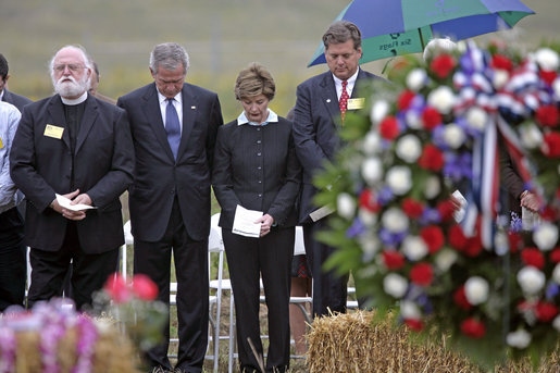 President George W. Bush and Laura Bush stand in silence after placing a wreath to commemorate the fifth anniversary of the September 11th attacks Monday, Sept. 11, 2006, in Shanksvillle, Pa., where United flight 93 crashed after the passengers fought against the terrorist hijackers. White House photo by Eric Draper