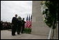 President George W. Bush and Laura Bush, accompanied by Sgt. Timothy Boyd of the Military District of Washington, stand before a memorial wreath Monday, Sept. 11, 2006, during a moment of silence at the Pentagon in Arlington, Va., to commemorate the fifth anniversary of Sept. 11, 2001 attacks. White House photo by Shealah Craighead