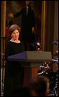 Mrs. Laura Bush welcomes guests to the East Room for entertainment Thursday night, Sept. 14, 2006, during the Thelonious Monk Institute of Jazz dinner at the White House. White House photo by Shealah Craighead