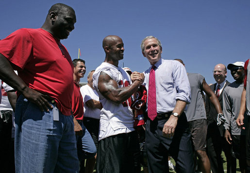 President George W. Bush shakes hands with Tampa Bay Buccaneers' running back Michael Pittman during his visit to the NFL team's training facility in Tampa, Fla., Thursday, Sept. 21, 2006. White House photo by Paul Morse