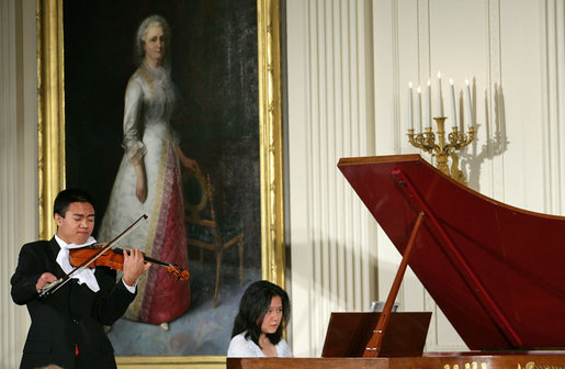 Violinist Adrian Anantawan and Amy Yang perform during the announcement of the President's Global Cultural Initiative in the East Room Monday, Sept. 25, 2006. White House photo by Shealah Craighead