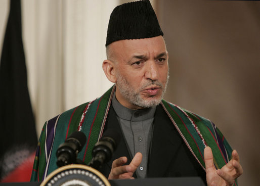 President Hamid Karzai, of the Islamic Republic of Afghanistan, responds to a reporter's question Tuesday, Sept. 26, 2006, during a joint availability with President George W. Bush in the East Room of the White House. Said President Karzai, "I think it is very important that we have more dedication and more intense work with sincerity, all of us, to get rid of the problems we have around the world." White House photo by Paul Morse