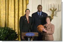 Mrs. Laura Bush stands with Ruth Riley, Detroit Shock WNBA player, left, and Brendan Haywood, Washington Wizards NBA player, after receiving the NBA Cares award Saturday, September, 30, 2006, during the National Book Festival opening ceremony in the East Room of the White House. White House photo by Shealah Craighead