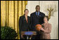 Mrs. Laura Bush stands with Ruth Riley, Detroit Shock WNBA player, left, and Brendan Haywood, Washington Wizards NBA player, after receiving the NBA Cares award Saturday, September, 30, 2006, during the National Book Festival opening ceremony in the East Room of the White House. White House photo by Shealah Craighead