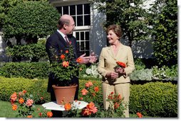 Mrs. Laura Bush smiles at Bill Williams, President and CEO of Harry & David Holdings, Monday, October 2, 2006, as she participates in a ceremony for the unveiling of the Laura Bush rose in The First Lady’s Garden at The White House. Founded in 1872, Jackson & Perkins is a leading hybridizer of garden roses and has launched The Laura Bush rose as part of the First Ladies Rose Series. The rose is a floribunda rose and has light yellow buds that open to a smoky coral color with yellow on the reverse petal.  White House photo by Shealah Craighead