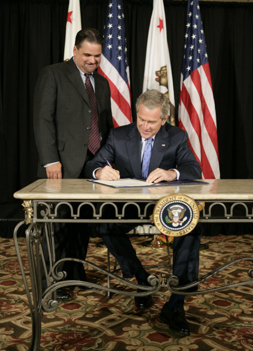 President George W. Bush signs S. 260, The Partners for Fish and Wildlife Act, in Stockton, Calif., Tuesday, Oct. 3, 2006. Pictured with President Bush is Congressman Richard Pombo, R-Ca. The legislation provides assistance to private landowners for voluntary projects to benefit federal trust species by promoting habitat improvement, restoration, enhancement, and establishment; and other public and private entities regarding fish and wildlife habitat restoration on private land. White House photo by Eric Draper
