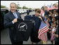 President George W. Bush holds up a T-shirt from George W. Bush Elementary School while visiting with students in Stockton, Calif., Tuesday, Oct. 3, 2006. White House photo by Eric Draper
