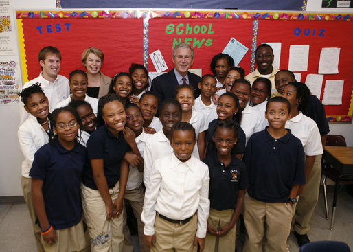 President George W. Bush and U.S. Secretary of Education Margaret Spellings pose for a photo with students during their visit Thursday, Oct. 5, 2006, to the Woodridge Elementary and Middle Campus in Washington, D.C. White House photo by Paul Morse