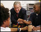 President George W. Bush talks with students during his visit Thursday, Oct. 5, 2006, in the SmartLab of the Woodridge Elementary and Middle Campus in Washington, D.C., where students demonstrated various math, science and technology projects.  White House photo by Paul Morse