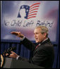 President George W. Bush gestures as he addresses his remarks Thursday, Oct. 5, 2006, at the Woodridge Elementary and Middle Campus in Washington, D.C., where President Bush praised the education advancements made through the No Child Left Behind law but also talked about ideas to strengthen the law in the future. White House photo by Paul Morse