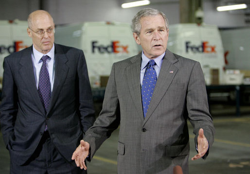 President George W. Bush addresses his remarks on the economy following his meeting with small-to-medium-sized business leaders Friday, Oct. 6, 2006, at the FedEx Express DCA Facility in Washington, D.C., during a roundtable discussion on job growth and the economy. U.S. Secretary of the Treasury Henry Paulson, is seen background-left. White House photo by Kimberlee Hewitt