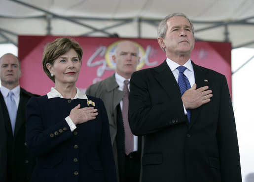 President George W. Bush and Mrs. Laura Bush stand for the National Anthem during the Christening Ceremony of the George H.W. Bush (CVN 77) in Newport News, Virginia, Saturday, Oct. 7, 2006. White House photo by Eric Draper