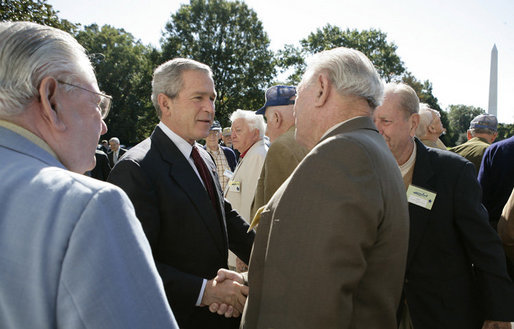 President George W. Bush welcomes veterans of the 57th Bomb Wing from World War II to the White House, Friday, Oct. 13, 2006. Approximately 10,800 airmen passed through the portals of the 57th Bomb Wing, a command composed of B-25 Mitchell medium bombers, during its time in combat from 1942 to 1945 in North Africa, Sicily, Corsica, and Italy. The B-25 Mitchell’s and their crews were known for their ability to take out bridges, gun positions, and for disrupting enemy troop communications. The 57th was nicknamed, "The Bridge Busters." The members are in Washington, D.C., for their association's annual reunion Oct. 11-16, 2006. White House photo by Eric Draper