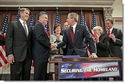 President George W. Bush shakes hands with Congressman Peter King, R-N.Y., chairman of the Homeland Security Committee, after signing H.R. 4954, the SAFE Port Act, in the Dwight D. Eisenhower Executive Office Building Friday, Oct. 13, 2006. Also pictured from left are Sen. Bill Frist, R-Tenn.; Sen. Susan Collins, R-Maine; Sen. Robert Bennett, R-Utah; Sen. Patty Murray, D-Wash.; and Sen. Norm Coleman, R-Minn.  White House photo by Paul Morse