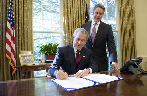 With Sen. Bill Frist (R-Tenn.) looking on, President George W. Bush signs into law S. 3728, the North Korea Nonproliferation Act of 2006, Friday, Oct. 13, 2006, in the Oval Office. White House photo by Eric Draper