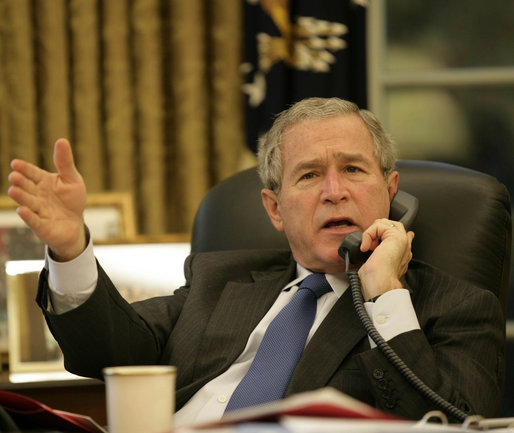 President George W. Bush gestures as he speaks with Iraq's Prime Minister Nouri al-Maliki during a telephone conversation Monday, Oct. 16, 2006, in the Oval Office. White House photo by Eric Draper