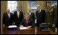 President George W. Bush signs into law H.R. 5122, the John Warner National Defense Authorization Act for Fiscal Year 2007, Tuesday, Oct. 17, 2006, in the Oval Office. Joining him are from left: Vice President Dick Cheney, Rep. Duncan Hunter of California, Secretary of Defense Donald Rumsfeld, Sen. John Warner of Virginia, and General Peter Pace, Chairman, Joint Chiefs of Staff. White House photo by Eric Draper