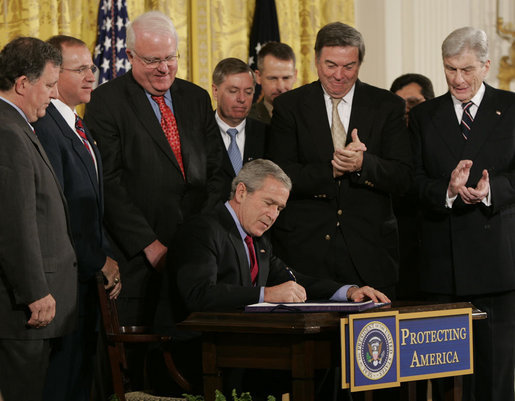 President George W. Bush signs into law S. 3930, the Military Commissions Act of 2006, during a ceremony Tuesday, Oct. 17, 2006, in the East Room of the White House. Joining him on stage, from left are: Utah Rep. Chris Cannon, Indiana Rep. Steve Buyer, Wisconsin Rep. Jim Sensenbrenner, Sen. Lindsey Graham of South Carolina, California Rep. Duncan Hunter, and Sen. John Warner of Virginia. General Peter Pace, Chairman of the Joint Chiefs of Staff, and U.S. Attorney General Alberto Gonzales are in the background. White House photo by Paul Morse