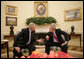President George W. Bush and the Prime Minister of the Republic of Croatia H.E. Ivo Sanader talk together in the Oval Office at the White House, Tuesday, Oct. 17, 2006. White House photo by Eric Draper