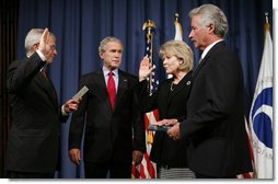 President George W. Bush attends the ceremonial swearing-in of Mary Peters as the 15th U.S. Secretary of Transportation, Tuesday, Oct. 17, 2006 at the Department of Transportation in Washington, D.C., as White House Chief of Staff Josh Bolten administers the oath of office and Peter’s husband, Terryl "Terry" Peters, Sr. holds the bible.  White House photo by Paul Morse