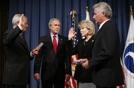 President George W. Bush attends the ceremonial swearing-in of Mary Peters as the 15th U.S. Secretary of Transportation, Tuesday, Oct. 17, 2006 at the Department of Transportation in Washington, D.C., as White House Chief of Staff Josh Bolten administers the oath of office and Peter’s husband, Terryl "Terry" Peters, Sr. holds the bible. White House photo by Paul Morse