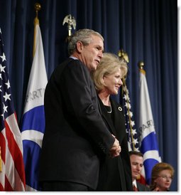 President George W. Bush congratulates Mary Peters following her ceremonial swearing-in as the 15th U.S. Secretary of Transportation, Tuesday, Oct. 17, 2006 at the Department of Transportation in Washington, D.C.  White House photo by Paul Morse