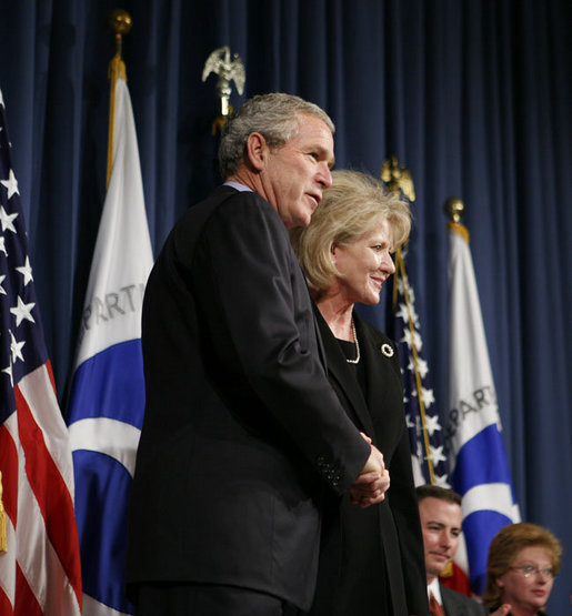 President George W. Bush congratulates Mary Peters following her ceremonial swearing-in as the 15th U.S. Secretary of Transportation, Tuesday, Oct. 17, 2006 at the Department of Transportation in Washington, D.C. White House photo by Paul Morse