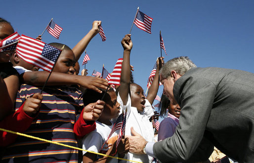 President George W. Bush greets flag-waving students at the Waldo C. Falkener Elementary School Wednesday, Oct. 18, 2006, in Greensboro, N.C., where he delivered remarks on the No Child Left Behind Act. White House photo by Paul Morse