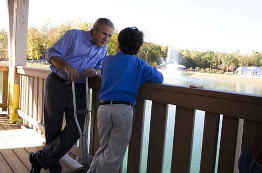 President George W. Bush shares a quiet moment with 10-year-old Hank Grissom Wednesday Oct. 18, 2006, at the Victory Junction Gang Camp in Randleman, N.C. The Charlotte, N.C. youngster, who has Spina Bifida, attends the camp, which was founded in 2004 by Kyle and Pattie Petty in honor of their son, Adam, to help enrich the lives of kids with chronic medical conditions or serious illnesses. White House photo by Paul Morse