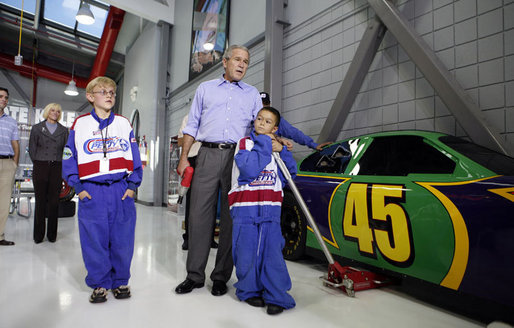 President George W. Bush gets a close-up view of the 45 car Wednesday, Oct. 18, 2006, at Victory Junction Gang Camp, Inc. with Will "Cheese" Kwapil, 12, left, who suffers from a congenital heart defect, and Pauly Rader, 9, who has a brain tumor. The camp, founded by Kyle and Pattie Petty, serves children primarily from North Carolina, South Carolina and Virginia with chronic medical conditions or serious illnesses. White House photo by Paul Morse