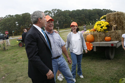 President George W. Bush talks with pumpkin roadside stand owner Bill Gaulmyer and Thina Patterson in Richmond, Va., Thursday, Oct. 19, 2006. White House photo by Paul Morse