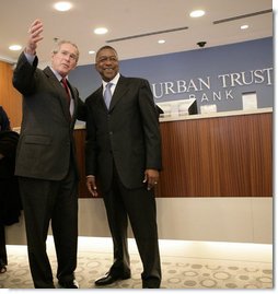 President George W. Bush is welcomed by Bob Johnson, founder and chairman of the RLJ Companies, to the Urban Trust Bank for a discussion on the economy with small business owners and community bankers, Monday, Oct. 23, 2006 in Washington, D.C. White House photo by Eric Draper
