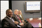 President George W. Bush sits with Bob Johnson, founder and chairman of the RLJ Companies, and Kathy Boden, right, president and CEO of Blue House Water Solutions , during a meeting to discuss the economy with small business owners and community bankers, Monday, Oct. 23, 2006 at the Urban Trust Bank in Washington, D.C. White House photo by Eric Draper