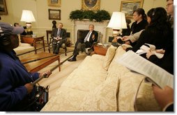 President George W. Bush speaks to reporters as he sits with NATO Secretary-General Jaap de Hoop Scheffer in the Oval Office Friday, Oct. 27, 2006.  White House photo by Kimberlee Hewitt