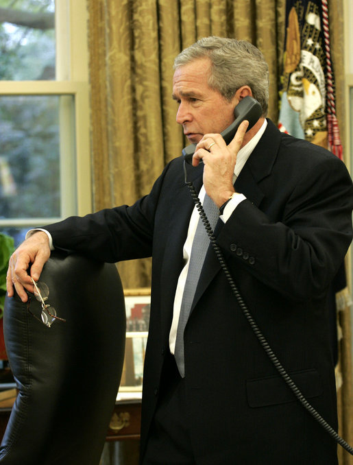 President George W. Bush makes a telephone call Friday, Oct. 27, 2006, to Tom Tidwell, Deputy Regional Forester, about the deaths Thursday of four firefighters in a Southern California wildfire. The firefighters were killed while battling the Esperanza fire near Palm Springs. White House photo by Paul Morse