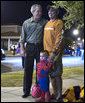 President George W. Bush poses for photos with a University of Texas fan and Spiderman Tuesday, Oct. 31, 2006, during a stop at a housing area at Robins Air Force Base, Ga. The President passed out M&Ms to the trick-or-treaters before his return to Washington, D.C. White House photo by Paul Morse
