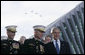 President George W. Bush talks with Chairman of the Joint Chiefs of Staff General Peter Pace, left, and Commandant of the Marine Corps, General Michael Hagee, as a fly over approaches at the dedication ceremony of the National Museum of the Marine Corps Friday, Nov. 10, 2006, in Quantico, Va. White House photo by Paul Morse