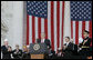 President George W. Bush is applauded as he addresses the Veteran’s Day ceremonies Saturday, Nov. 11, 2006, at Arlington National Cemetery in Arlington, Va. White House photo by Kimberlee Hewitt