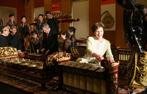 President George W. Bush and Laura Bush create their own music after a traditional gamelan musical performance Thursday, Nov. 16, 2006, at the Asian Civilisations Museum in Singapore. The Bushes are scheduled to depart Singapore on Friday for Vietnam and the 2006 APEC Summit. White House photo by Paul Morse