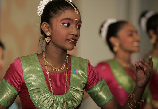 A student from the Bukit View Primary School in Singapore performs a cultural dance with classmates for President George W. Bush and Mrs. Laura Bush during their visit Thursday, Nov. 16, 2006, to the city's Asian Civilisations Museum. White House photo by Paul Morse