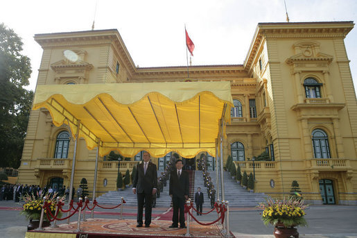 President George W. Bush and President Nguyen Minh Triet participate in an arrival ceremony at the Presidential Palace in Hanoi Friday, Nov. 17, 2006. The President thanks President Nguyen for hosting APEC and said he looked "forward to continuing to work to make sure our bilateral relations are close." White House photo by Eric Draper