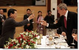 President George W. Bush exchanges toasts with Viet President Nguyen Minh Triet during a State Banquet Friday, Nov. 17, 2006, at the International Convention Center in Hanoi. President Bush told his host, "Vietnam is a country that's taking its rightful place as a strong and vibrant nation," adding he hoped its people know they have the friendship of the American people.  White House photo by Paul Morse