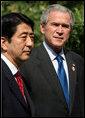 President George W. Bush and Prime Minister Shinzo Abe of Japan talk with the media during a photo opportunity Saturday, Nov. 18, 2006, following their lunch at the Sheraton Hanoi hotel. White House photo by Eric Draper
