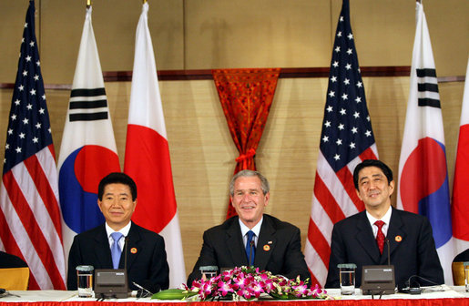 President George W. Bush sits with President Roh Moo-Hyun, of the Republic of Korea, left, and Japan's Prime Minister Shinzo Abe during a trilateral discussion Saturday, Nov. 18, 2006, at the Sheraton Hanoi hotel in Hanoi, where they are participating in the Asia Pacific Economic Cooperation summit. White House photo by Eric Draper