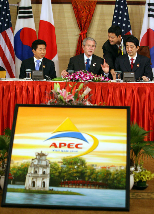 President George W. Bush pauses during a trilateral meeting Saturday, Nov. 18, 2006, with Shinzo Abe, right, Prime Minister of Japan, and President Roh Moo-Hyun, of the Republic of Korea. White House photo by Eric Draper