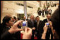 President George W. Bush is the focus of onlookers as he departs the National Conference Center Saturday, Nov. 18, 2006, following the first session of the 2006 APEC Summit in Hanoi. White House photo by Eric Draper