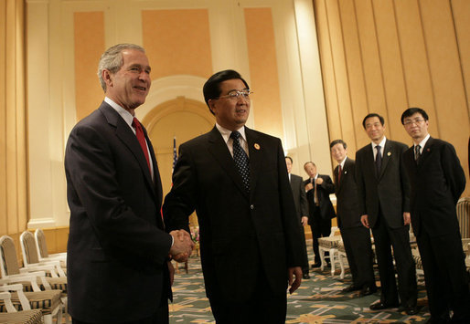 President George W. Bush is greeted by President Hu Jintao of China at the Hanoi Daewoo Hotel in Hanoi after his arrival Sunday, Nov. 19, 2006, for bilateral talks. President Bush told President Hu, "China is a very important nation, and the United States believes strongly that by working together, we can help solve problems." White House photo by Eric Draper