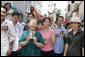 Onlookers line the street of Ho Chi Minh City Monday, Nov. 20, 2006, holding pictures of President George W. Bush, who was joined by Mrs. Laura Bush for a daylong visit to the city. White House photo by Shealah Craighead