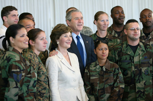 President George W. Bush and Laura Bush pose for photos with military personnel during a breakfast Tuesday, Nov. 21, 2006, at the Officers Club at Hickam Air Force Base in Honolulu, Hawaii. White House photo by Eric Draper