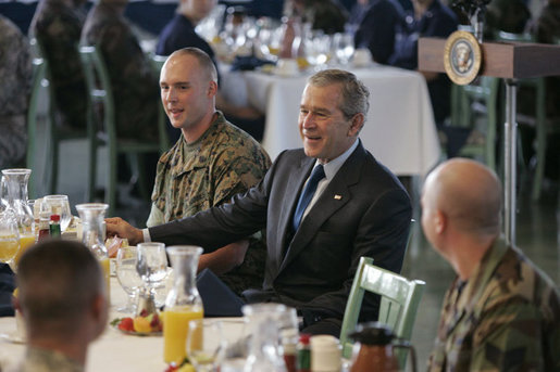 President George W. Bush visits with military personnel during a breakfast Tuesday, Nov. 21, 2006, at the Officers Club at Hickam Air Force Base in Honolulu, Hawaii. White House photo by Paul Morse
